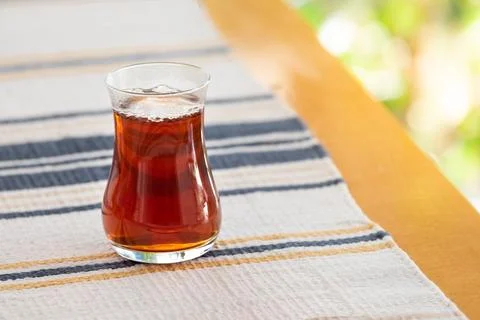 A glass of tea on an authentic table cloth Stock Photos