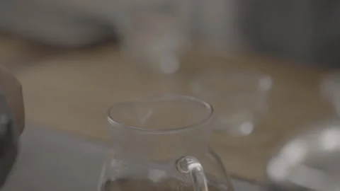 Glass Tea Infuser Pouring Into Serving Pitcher Stock Footage 346207361