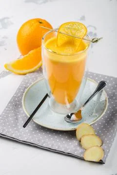 A glass of tea with orange and ginger Stock Photos
