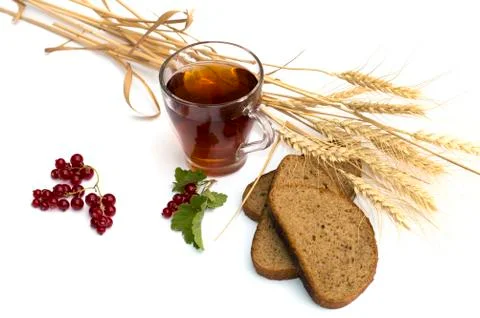 Glass of tea, wheat about fields and bread Stock Photos
