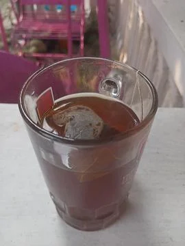 A glass of tea on a white surface Stock Photos