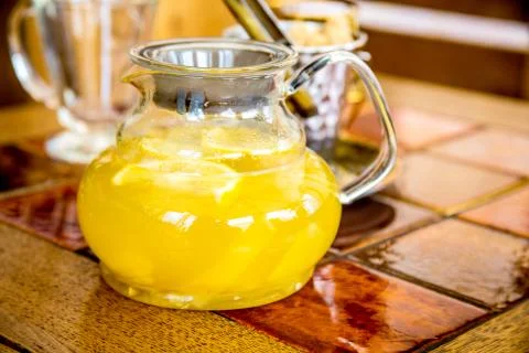 Glass teapot with ginger tea is on the table. Stock Photos