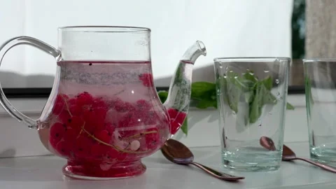 Glass teapot with red currant tea Stock Footage 321133033