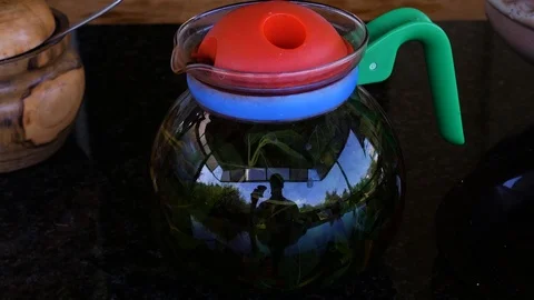 Glass teapot with reflection of young man drinking tea Vídeos de archivo 113742730