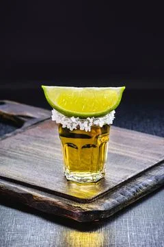 Glass of tequila, black background, typical mexican drink Stock Photos