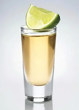 A glass of tequila with a slice of lime Stock Photos