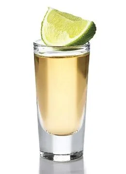 A glass of tequila with a slice of lime Stock Photos