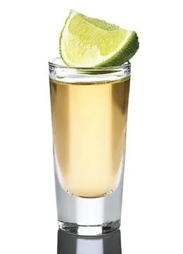 A glass of tequila with a slice of lime Stock Photos