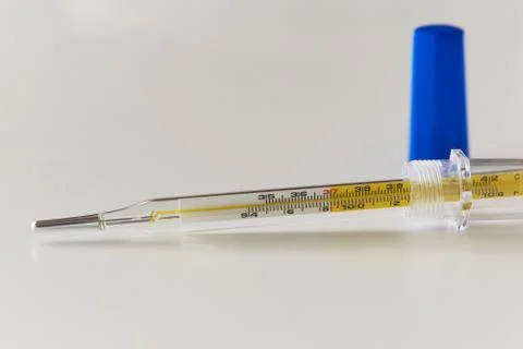 A glass thermometer on the table Stock Photos