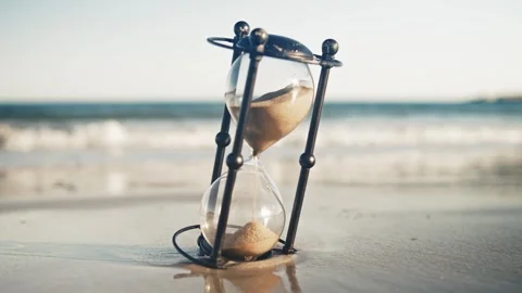 Glass Timer Counting Down Seconds On Seashore With Sunset And Approaching Waves Stock Footage 316702138