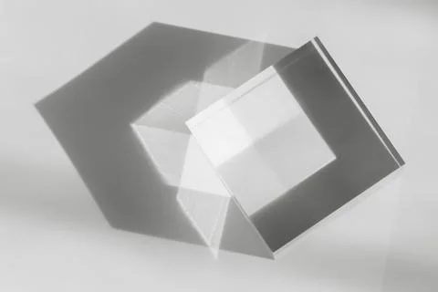 Glass transparent cube with sun reflection, light and shadow on white background Stock Photos