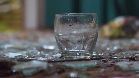 A glass of vodka on the awesome background of broken glass. theft Видео 80807723