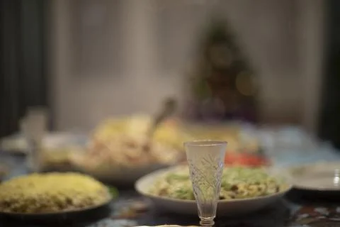 Glass of vodka on table. Festive table. Glass for alcoholic beverage. Stock Photos
