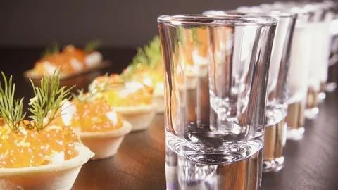 A glass of vodka on the table with a snack Stock Footage 92030580