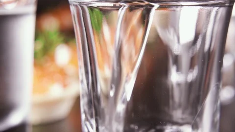 A glass of vodka on the table with a snack Stock-Footage 92030719