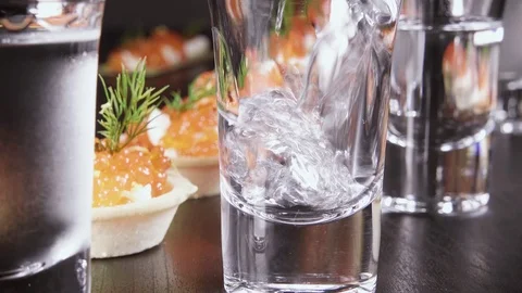 A glass of vodka on the table with a snack Stock Footage 92030846
