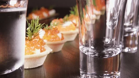 A glass of vodka on the table with a snack Stock Footage 92030998