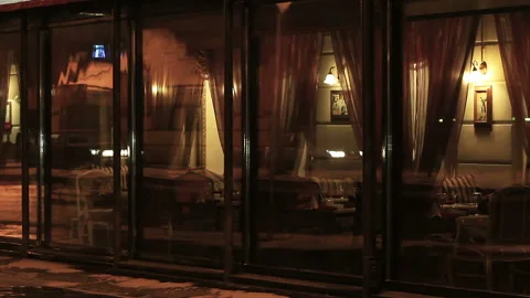 Glass wall and Big Windows of a restaurant in the evening Stock Footage 161297737