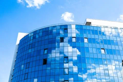 Glass wall facade with cloud sky reflection. Modern urban architecture backgr Photos