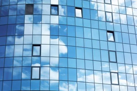 Glass wall facade with cloud sky reflection. Modern urban architecture backgr Stock-Fotos