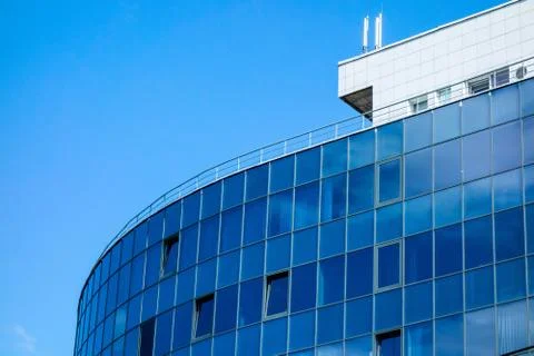 Glass wall facade with cloud sky reflection. Modern urban architecture backgr 库存照片