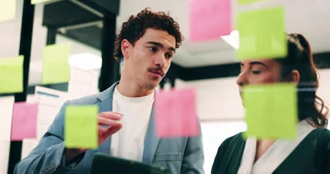 Glass wall, sticky notes or team in office with tablet, problem solving or Stock Footage 336238814