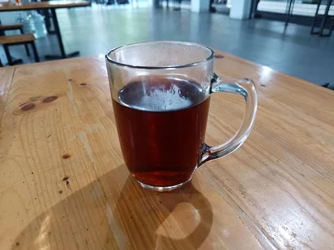 A glass of warm tea on the table. Stock Photos