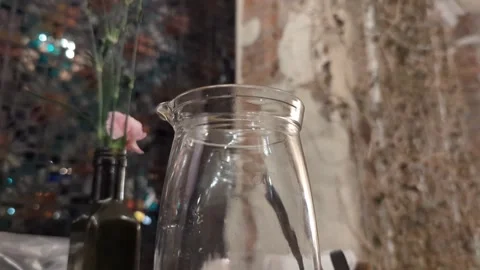 Glass of Water and Flower on Table in Cozy Cafe with Mosaic Window 4k Stock Footage 302881151