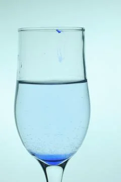 Glass of water and ink Stock Photos