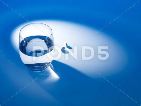 Glass of water and pills Stock Photos