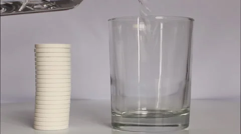 Glass of water with effervescent tablet Stock Footage 6530231
