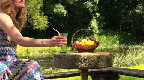 Glass water fruit on stone table, girl enjoying warm weather Vidéo 41501028