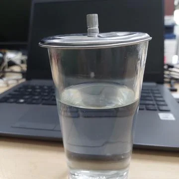 A glass of water prepared while working in front of a laptop Stock Photos