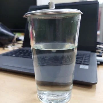 A glass of water prepared while working in front of a laptop Stock Photos
