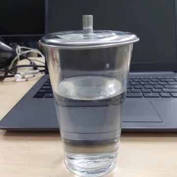 A glass of water prepared while working in front of a laptop Stock Photos