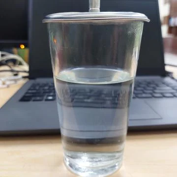 A glass of water prepared while working in front of a laptop Stock Photos