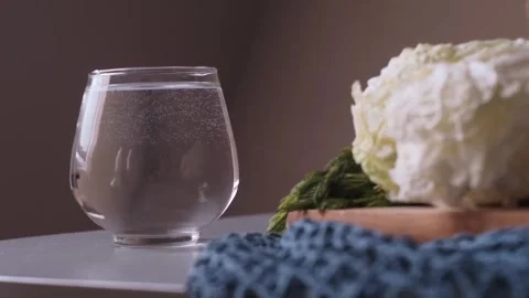 A glass of water sits on the table, part of morning rituals promoting a healthy Video stock 270541245