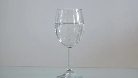 A glass of water in which manganese is dissolved Stock Footage 80998057