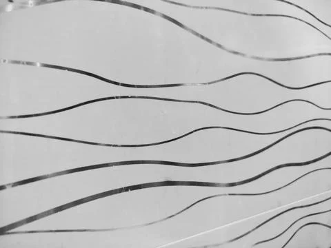 Glass with a wavy line pattern. Blurry background Stock Photos