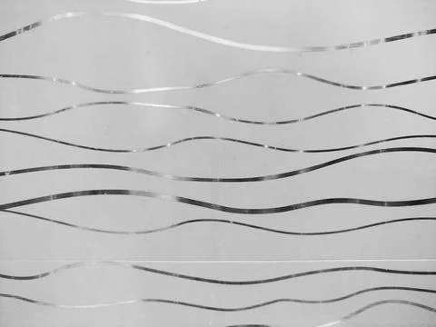 Glass with a wavy line pattern. Blurry background Stock Photos