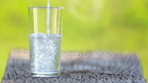 A glass into which pour fresh spring water. Stock Footage 114618864