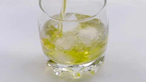 Glass of whiskey with ice cube. Stock Footage 239228616