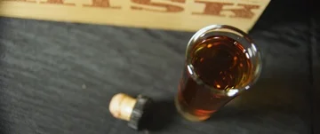 Glass of whiskey on table Stock Footage 85885635