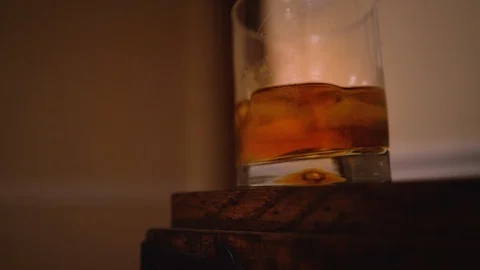 A Glass of Whiskey On a Table Stock Footage 97277185