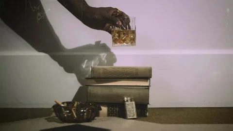 Glass of Whisky Placed on a Stack of Books, Cozy Still Life with Alcoholic Drink Video stock 312740565