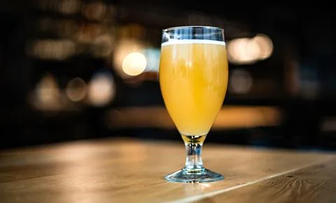 Glass With White Wheat Beer On A Table Stock Photos