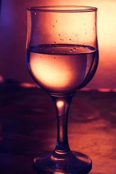 A glass of white wine on a bright yellow background, Foto stock