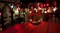 Glass Of White Wine Night On Balcony Table View Of City Streets HD Footage