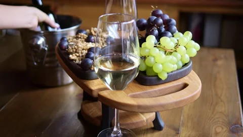 Glass of white wine sits elegantly against background of assorted fruits Wine Stock Footage 273206866
