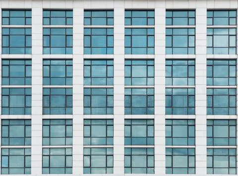 The glass window pattern on the building wall with the cloud reflection. Stock Photos